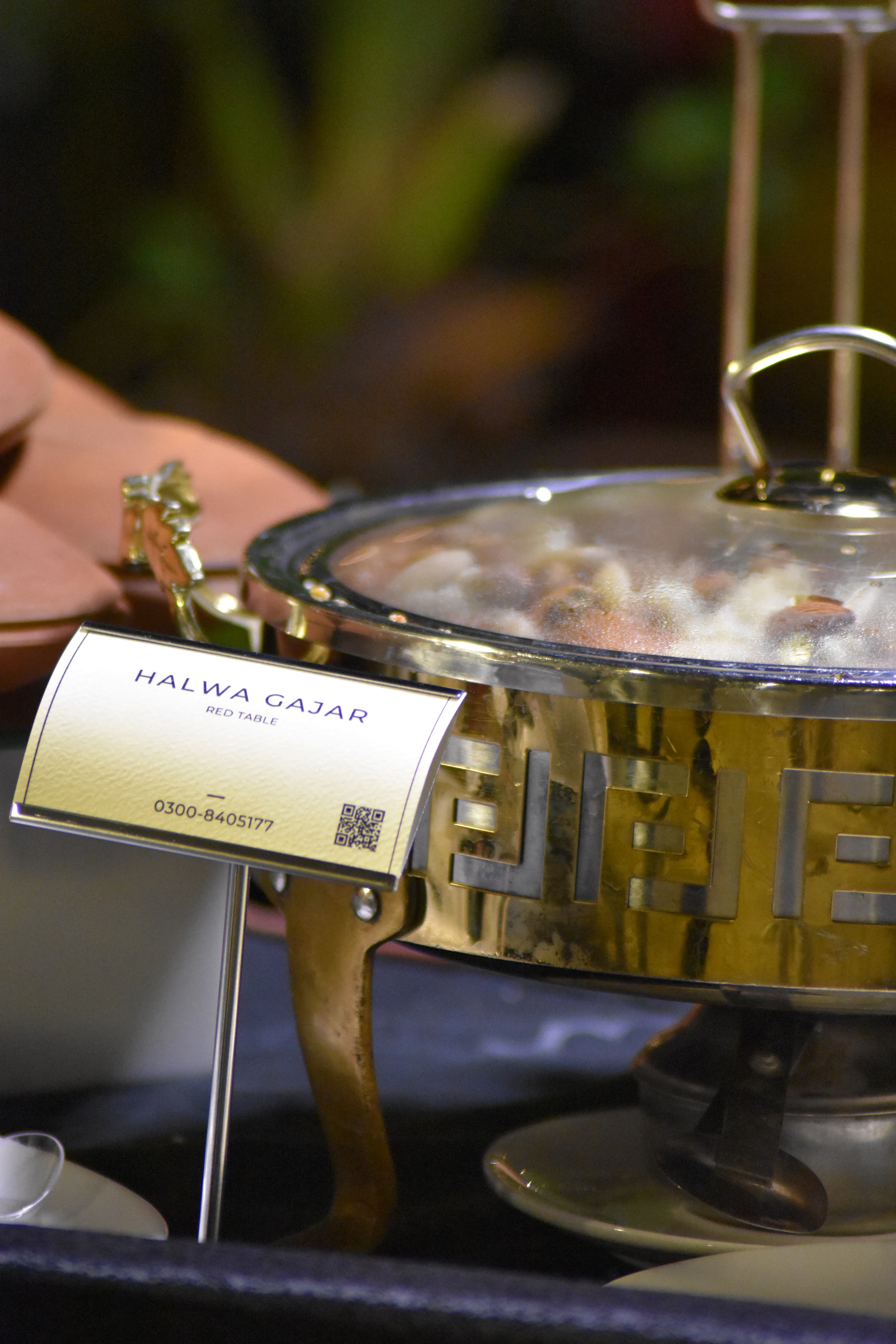 Fresh gajar halwa served in a brass chafing dish